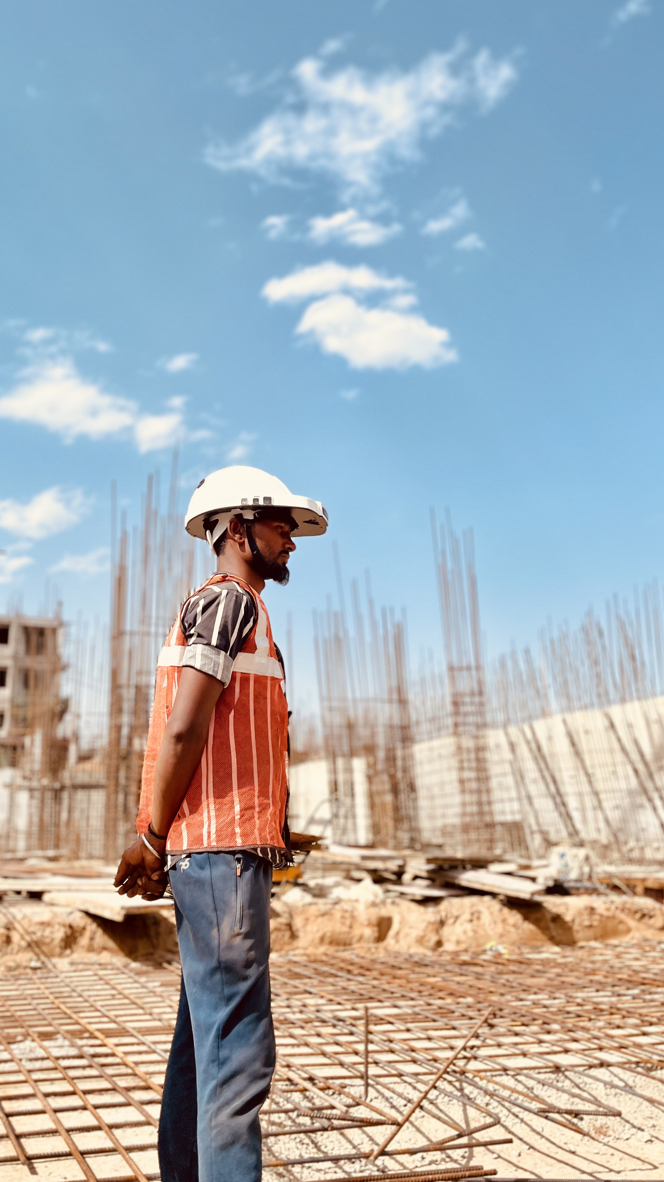 man walking in front of textured wall