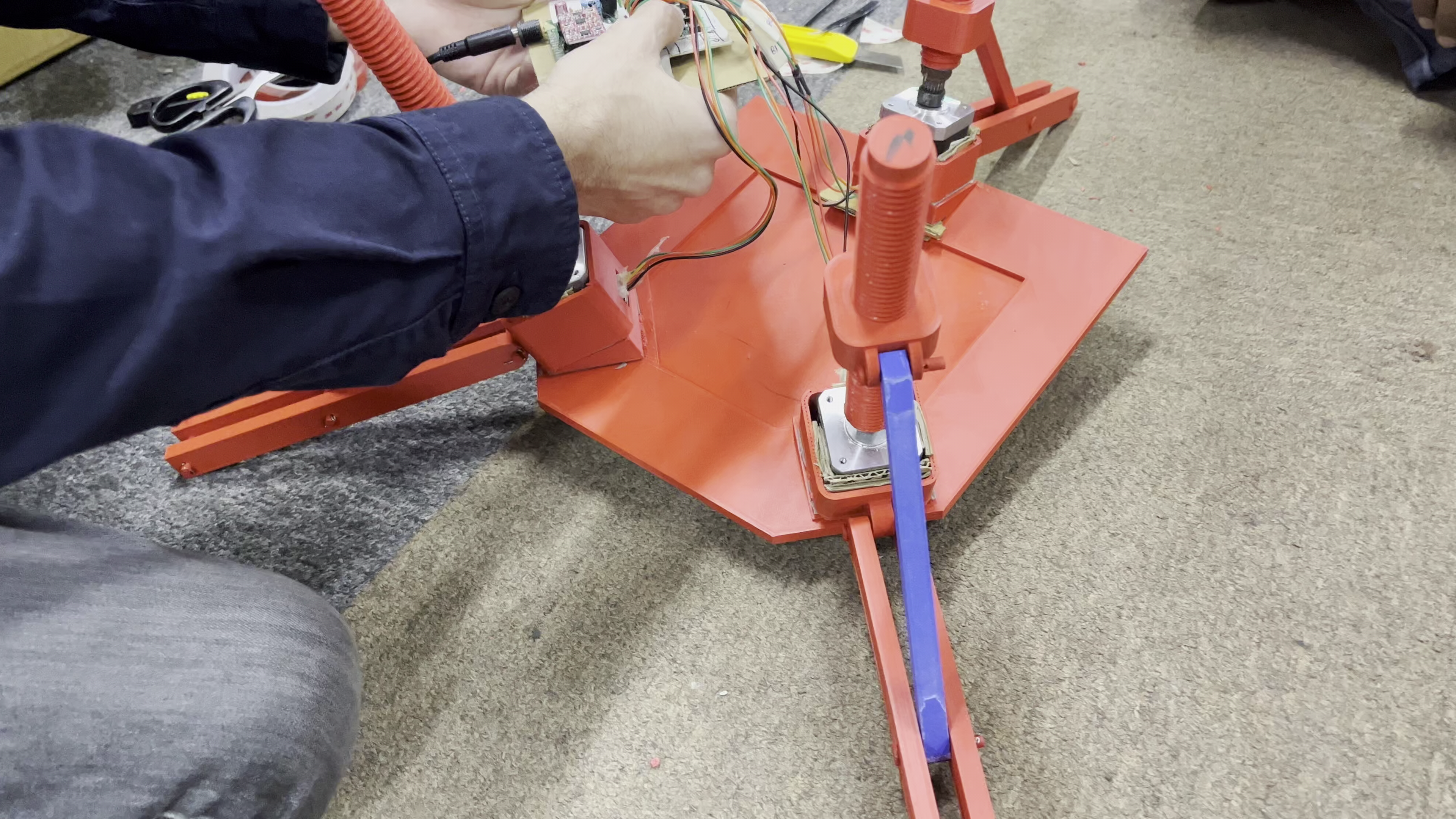 two people sitting on a ledge talking